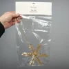 Bungalow Topstjerne i perler og metal, Clio Champagne